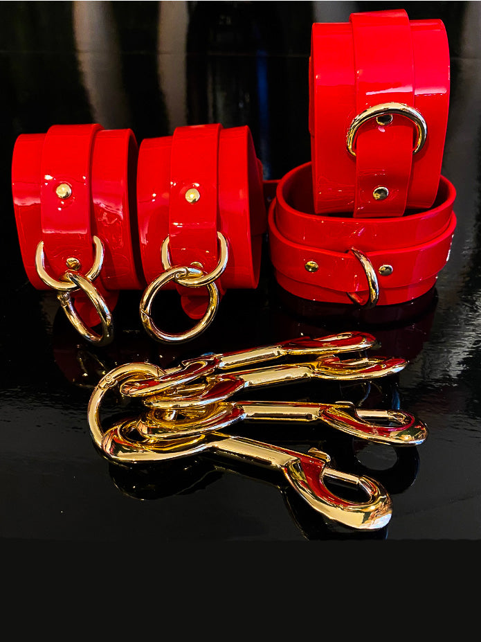 Red high-gloss handcuffs, leg irons and hogtie